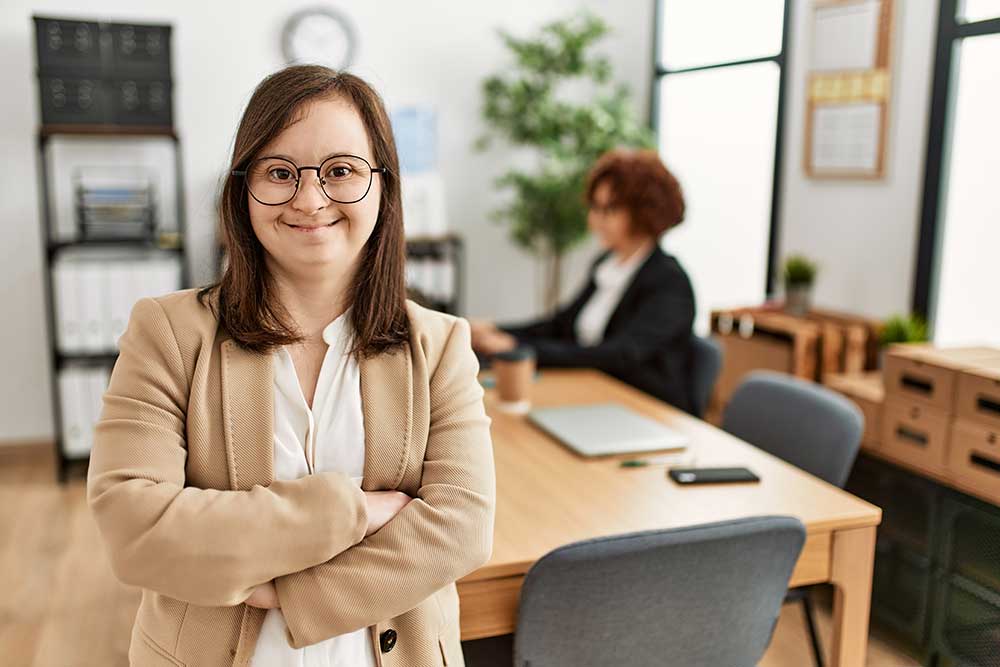 Down syndrome girl working at inclusive teamwork