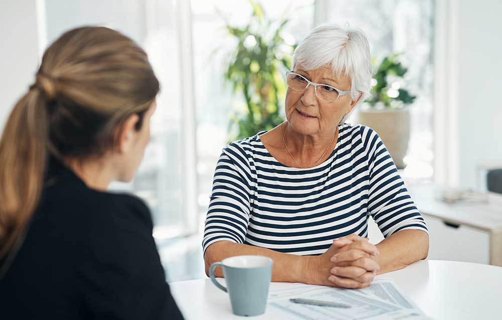 senior woman talking with lawyer